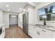 Modern kitchen featuring stainless steel appliances, granite counters, and stylish white cabinetry at 7030 19Th N Way, St Petersburg, FL 33702