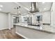 Bright kitchen with stainless steel appliances, stylish range hood, and granite island at 7030 19Th N Way, St Petersburg, FL 33702
