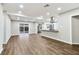 Open concept floorplan features a living area and kitchen with stainless steel appliances and a large sliding glass door at 7030 19Th N Way, St Petersburg, FL 33702