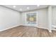 Spacious living room featuring hardwood floors and sliding glass doors leading to a screened-in patio at 7030 19Th N Way, St Petersburg, FL 33702