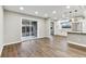 Open concept living space with hardwood floors and sliding glass doors connecting to the kitchen at 7030 19Th N Way, St Petersburg, FL 33702