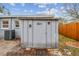 Backyard view of the storage shed, exterior of the home, and air conditioning condenser at 7030 19Th N Way, St Petersburg, FL 33702