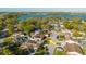 Community aerial view with lake, solar panels, fenced yard, and convenient access to the main highway at 7213 Trinity Pl, Tampa, FL 33610