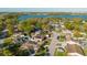 Aerial shot of a neighborhood near a lake, showcasing homes, streets, and lush greenery at 7213 Trinity Pl, Tampa, FL 33610