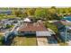 Aerial view of a home with solar panels, a carport, and a well-maintained yard in a suburban neighborhood at 7213 Trinity Pl, Tampa, FL 33610