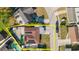 Real estate aerial view featuring backyard, fences, solar panels, carport, nearby lake and swimming pool at 7213 Trinity Pl, Tampa, FL 33610