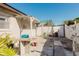 A well-maintained backyard featuring a granite table, white fencing, and a covered patio at 7213 Trinity Pl, Tampa, FL 33610