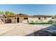View of the backyard featuring a covered patio and sun-exposed patio at 7213 Trinity Pl, Tampa, FL 33610