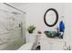 Stylish bathroom features a glass-enclosed shower, decorative sink, modern mirror, and neutral colors at 7213 Trinity Pl, Tampa, FL 33610