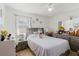 Bright bedroom featuring a comfortable bed, neutral decor, dresser and vanity at 7213 Trinity Pl, Tampa, FL 33610