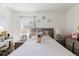 Bright bedroom featuring a comfortable bed, neutral decor, dresser and vanity at 7213 Trinity Pl, Tampa, FL 33610