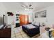 Bedroom with ceiling fan, closet with wood doors, and decorative wall art at 7213 Trinity Pl, Tampa, FL 33610