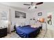 Bedroom features neutral color scheme, wall art, and well-lit vanity area at 7213 Trinity Pl, Tampa, FL 33610