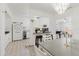 View of dining room leading into updated kitchen with breakfast bar seating at 7213 Trinity Pl, Tampa, FL 33610