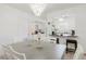 Dining room with chandelier, kitchen view, and neutral tones at 7213 Trinity Pl, Tampa, FL 33610