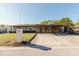 Front exterior of brick home featuring covered carport and driveway on a sunny day at 7213 Trinity Pl, Tampa, FL 33610