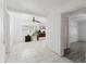 Hallway leading into a space with a ceiling fan and natural light from a window at 7213 Trinity Pl, Tampa, FL 33610