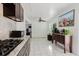 Bright kitchen featuring granite countertops, stainless steel appliances and tile flooring at 7213 Trinity Pl, Tampa, FL 33610