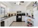 Updated kitchen boasts white cabinets, granite countertops, stainless steel appliances, and tile flooring at 7213 Trinity Pl, Tampa, FL 33610