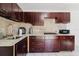 Remodeled kitchen with sleek cabinetry, stainless steel appliances, modern fixtures, and durable countertops at 7213 Trinity Pl, Tampa, FL 33610