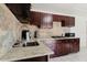 This kitchen features granite countertops and wooden cabinets, creating a warm and inviting culinary space at 7213 Trinity Pl, Tampa, FL 33610