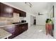 Bright kitchen with dark wood cabinets, tile floors, and an adjacent dining area for easy entertaining at 7213 Trinity Pl, Tampa, FL 33610