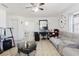 Open-concept living room with a cozy sofa, a desk, and modern decor for comfortable living at 7213 Trinity Pl, Tampa, FL 33610
