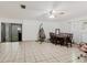 Large living room features tile flooring, ceiling fan, lots of natural light, and room for furniture at 7213 Trinity Pl, Tampa, FL 33610