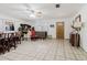 Spacious living room featuring tile flooring, a ceiling fan, and a front door at 7213 Trinity Pl, Tampa, FL 33610