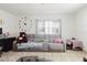 Cozy living room featuring a comfortable gray sofa, decorative pillows and a large wall clock at 7213 Trinity Pl, Tampa, FL 33610