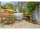 Inviting backyard patio with seating, covered greenhouse, and lush plants creating a serene atmosphere at 8306 N 10Th St, Tampa, FL 33604