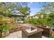 Secluded backyard patio with comfortable wicker seating and lush landscaping offering a private outdoor retreat at 8306 N 10Th St, Tampa, FL 33604