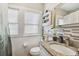 Stylish bathroom featuring granite countertops, modern fixtures, and tiled walls at 8306 N 10Th St, Tampa, FL 33604