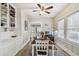 Well-lit dining room with wood floors, large windows, and built-in cabinets at 8306 N 10Th St, Tampa, FL 33604