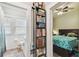 Hallway view shows bathroom and bedroom with book shelving in between at 8306 N 10Th St, Tampa, FL 33604