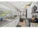 Bright kitchen features granite counters, stainless appliances, and a window overlooking the yard at 8306 N 10Th St, Tampa, FL 33604