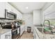 Modern kitchen featuring granite countertops, stainless steel appliances, and ample cabinet space at 8306 N 10Th St, Tampa, FL 33604