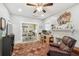 Cozy living room features a decorative fireplace, ceiling fan, and adjacent dining area at 8306 N 10Th St, Tampa, FL 33604
