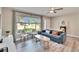 Inviting living room featuring stylish seating, a large window with natural light, and a cozy atmosphere at 930 Dumont Dr, Dunedin, FL 34698