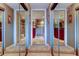 Bathroom entrance with mirrored closets on either side leading to the primary ensuite at 936 Pinellas Bayway S # T-7, Tierra Verde, FL 33715