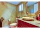 Powder room with custom vanity, granite countertop, vessel sink, and faux-finished walls at 936 Pinellas Bayway S # T-7, Tierra Verde, FL 33715