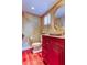 Powder room with custom vanity, granite countertop, vessel sink, and faux-finished walls at 936 Pinellas Bayway S # T-7, Tierra Verde, FL 33715