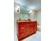Bathroom features cherry cabinets, granite counters and framed mirror at 936 Pinellas Bayway S # T-7, Tierra Verde, FL 33715