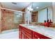Bathroom features tub-shower, cherry cabinets, and granite counters at 936 Pinellas Bayway S # T-7, Tierra Verde, FL 33715