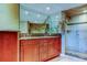 The bathroom features a double vanity, tile floors, tiled walls, and a tiled walk-in shower at 936 Pinellas Bayway S # T-7, Tierra Verde, FL 33715