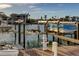 Boat lift and dock along the waterfront with boats in the harbor at 936 Pinellas Bayway S # T-7, Tierra Verde, FL 33715