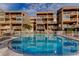 Community pool is shared by multilevel condominiums with multiple balconies and outdoor spaces at 936 Pinellas Bayway S # T-7, Tierra Verde, FL 33715