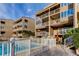 Condominium complex with shared pool featuring multiple balconies with views of community at 936 Pinellas Bayway S # T-7, Tierra Verde, FL 33715