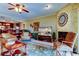 Spacious living room featuring a stone fireplace, a ceiling fan, and an open floorplan at 936 Pinellas Bayway S # T-7, Tierra Verde, FL 33715