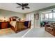 Spacious main bedroom boasts a ceiling fan, ensuite office area, and access to a private balcony at 936 Pinellas Bayway S # T-7, Tierra Verde, FL 33715